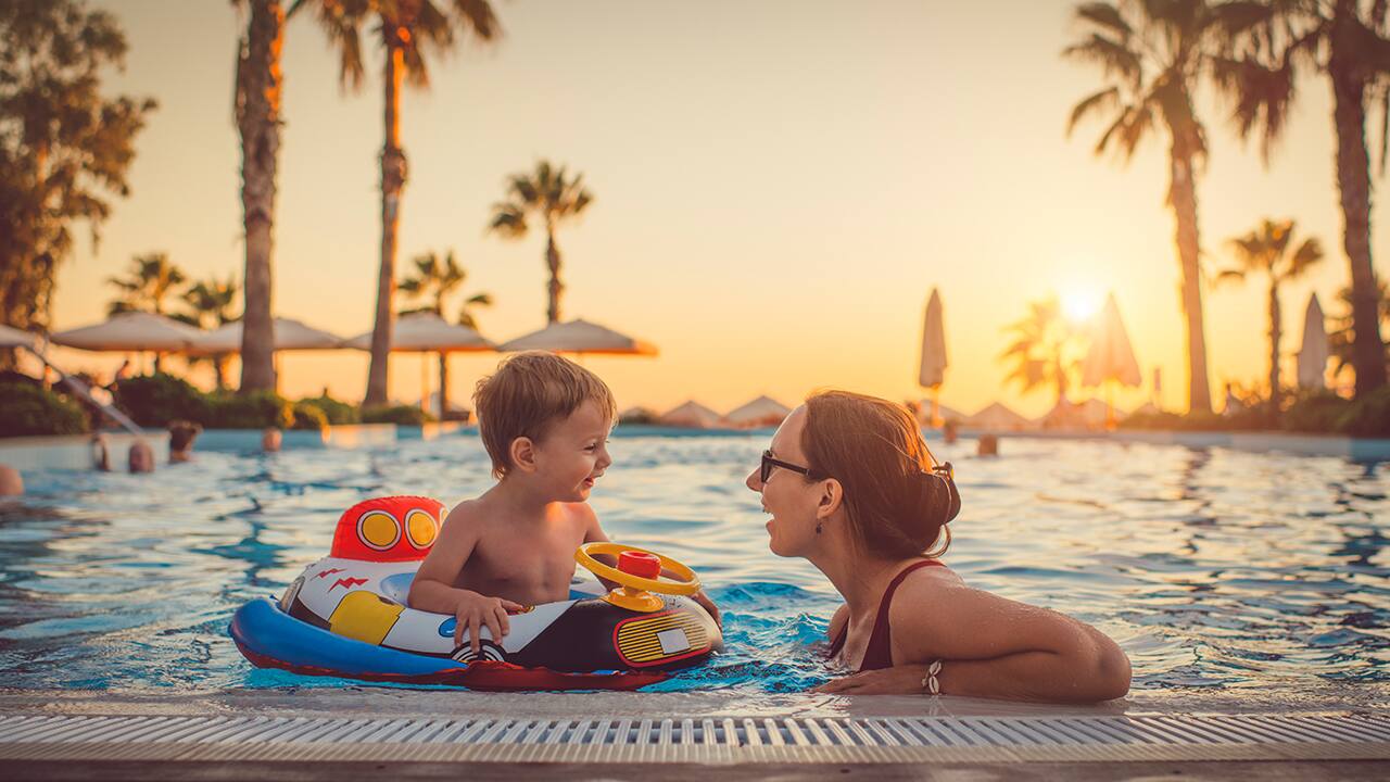 mother with baby in a pool booked using booking.com